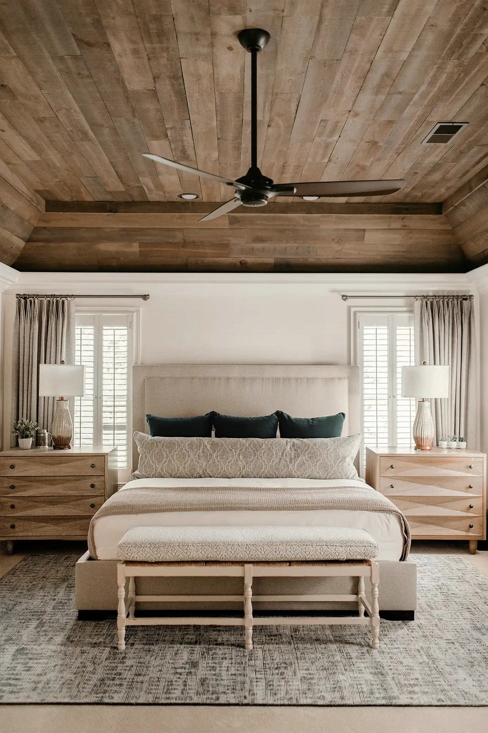 wood ceiling | primary bedroom | master bedroom | neutral bedroom | organic modern bedroom | wood tray ceiling | light stained wood nightstands | serene bedroom design | upholstered bench seat | long pillow | lumbar pillow