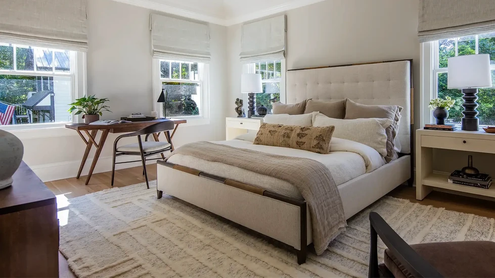 neutral bedroom | bedroom design | neutral master bedroom | organic modern | cream duvet | neutral window treatment | neutral area rug | neutral textured area rug | midcentury modern wood desk | midcentury modern wood chair | off white tufted headboard | cream tufted headboard | white oak floor | bedroom black table lamp | bedroom decor | beige bed throw blanket | neutral bed throw blanket