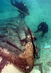 Divers examine the hull of the Henrietta Marie.