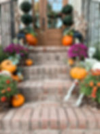 Fall front porch stoop. How to decorate small porch steps for the seasons. Pumpkin stacked stair steps with mums and pretty floral greenery. How to create a Fall Pottery Barn inspired porch for less.