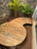 A circular wooden deck under construction, showcasing detailed woodworking and custom carpentry skills in Kauai.