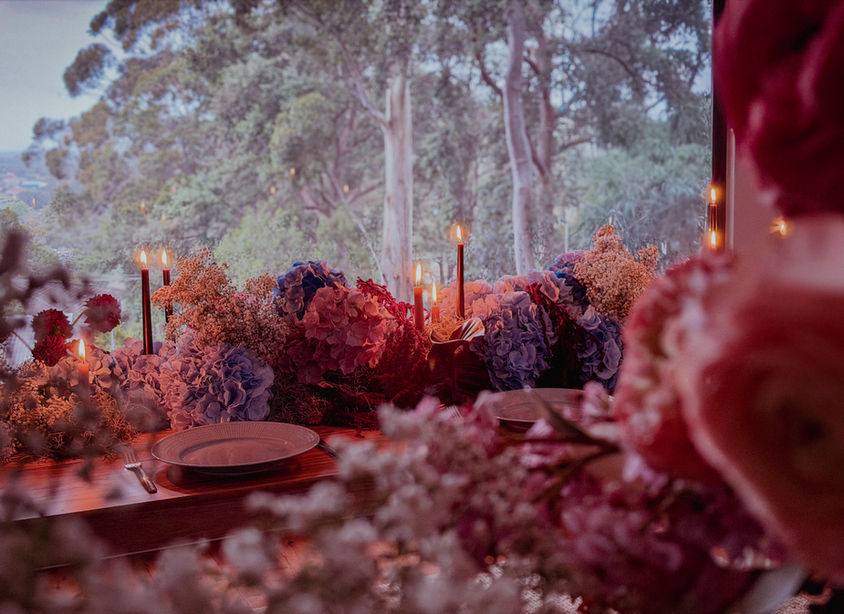 Event dinner flowers with hydrangea, amaranths, baby's breath, congo leaves, candle styling