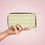 Thumbnail: Front of green and white leaf pattern zipper pouch on pink background.