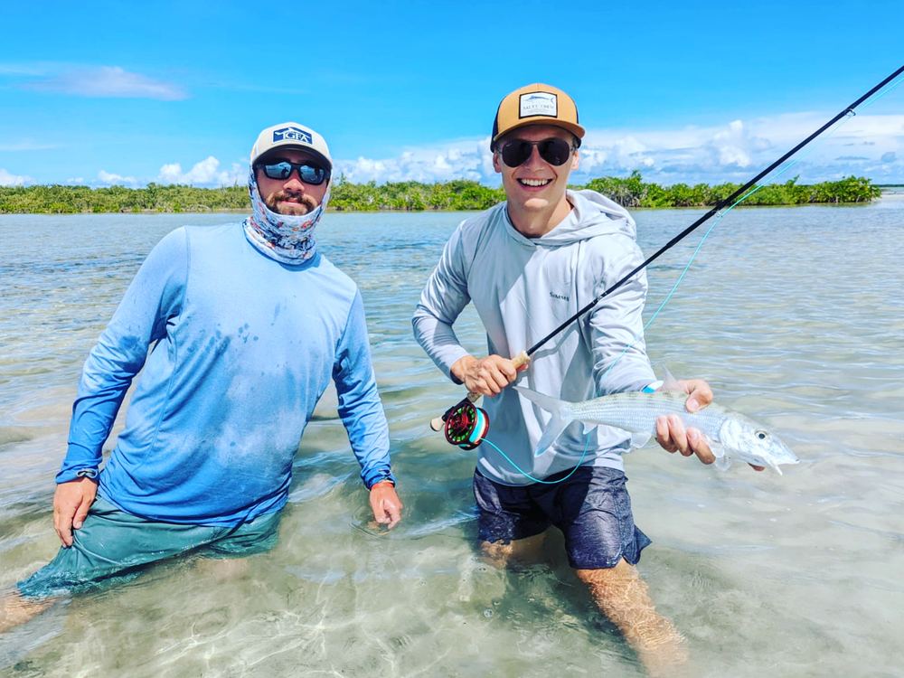 Two anglers with a bonefish on a cruise ship charter