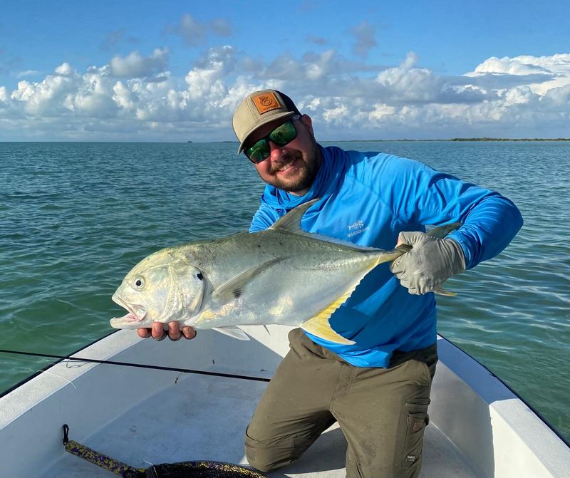 Angler with a jack crevalle on the boat