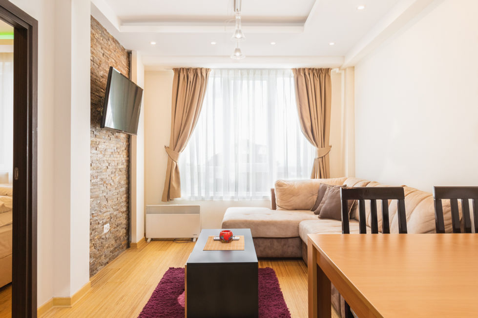 Interior photography - Wide view of apartment living room with window and dining area