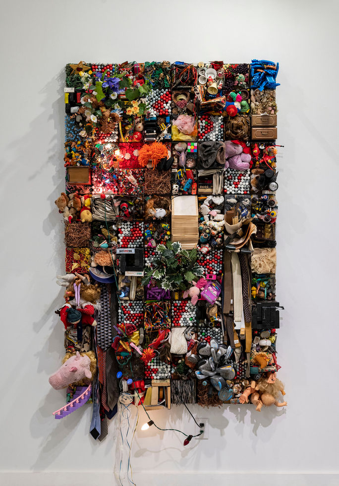 Mixed media wall art
Emilio Maldonado installations
Assemblage art sculptures
Found objects in contemporary art
Colorful collage installations
Wall-mounted art sculptures
Upcycled materials in art
Interactive art displays
Art reflecting consumer culture
Unique mixed-media art pieces
A vibrant mixed-media wall installation by Emilio Maldonado, featuring an assemblage of found objects including toys, electronics, textiles, and everyday items. The intricate composition creates a colorful and chaotic tapestry, showcasing themes of consumerism, memory, and identity. The installation is mounted on a plain white wall with visible wires and light bulbs adding an interactive and dimensional element.