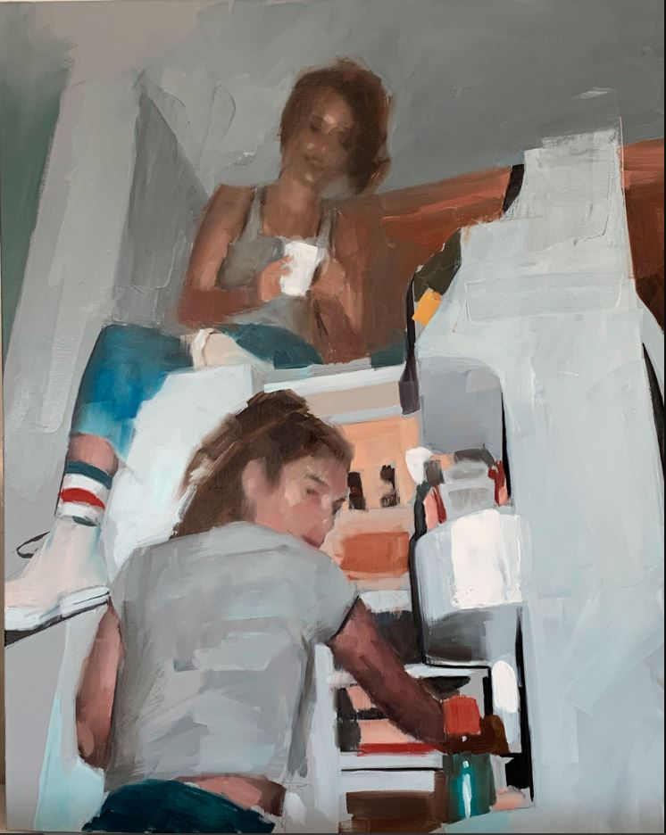 A young girl sits on a fridge while another stand in the open door