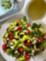 Apple Lime Vinaigrette being poured over salad