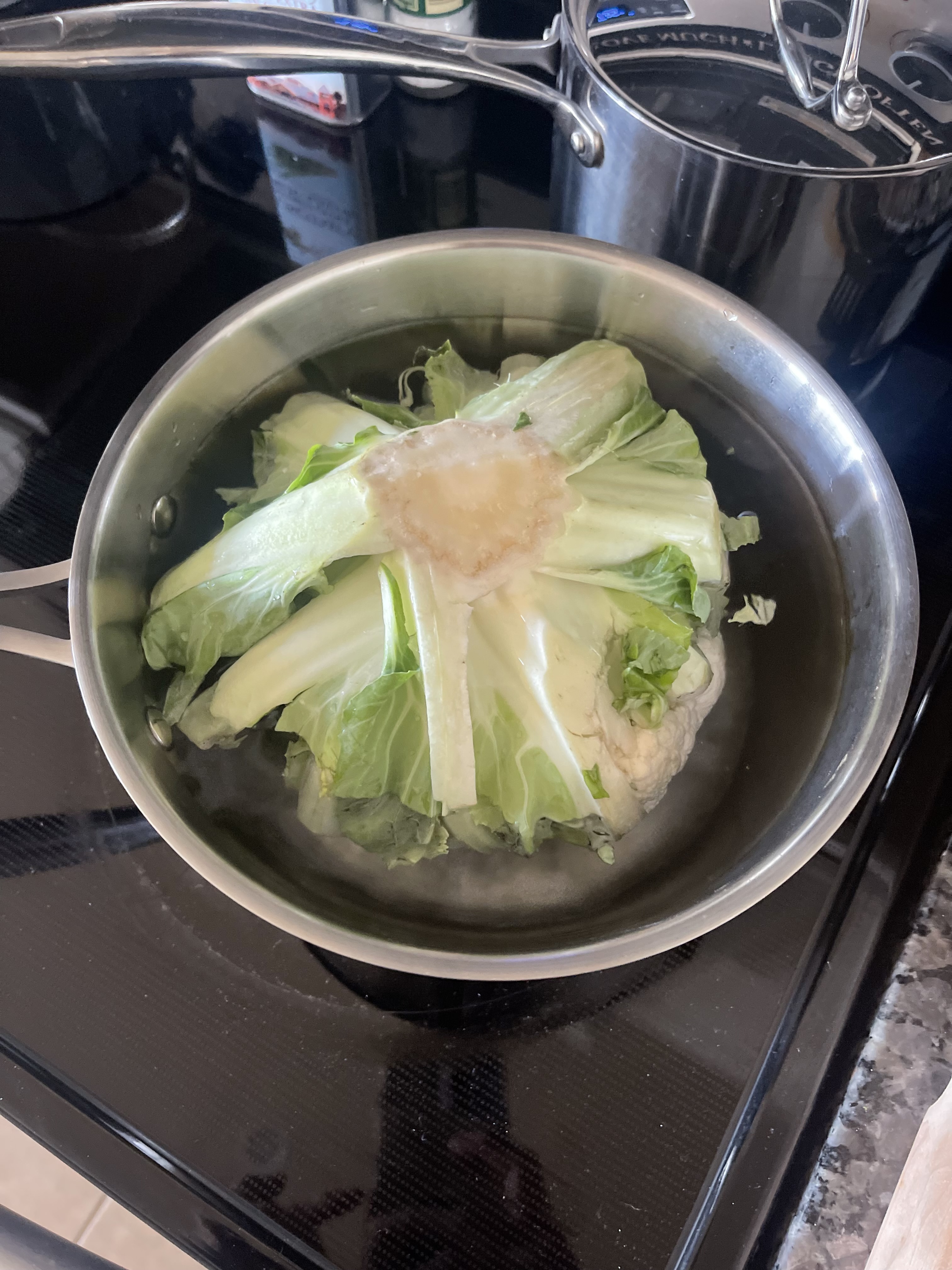 boiling cauliflower upside down in pot on stove