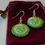 Thumbnail: Glossy cucumber earrings with gold-tone hook closures and acrylic slices resembling real cucumbers