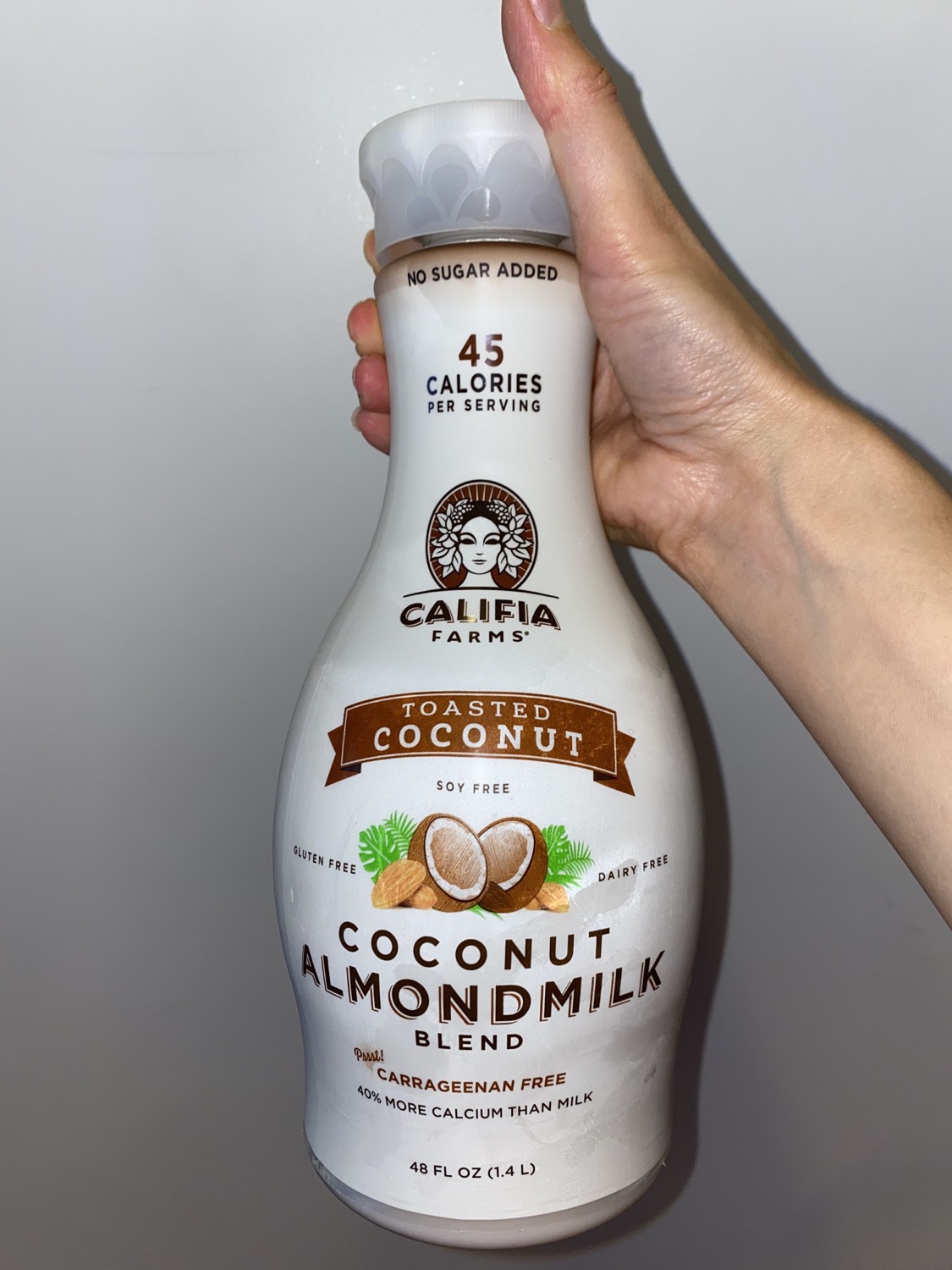 hand holding coconut almond milk