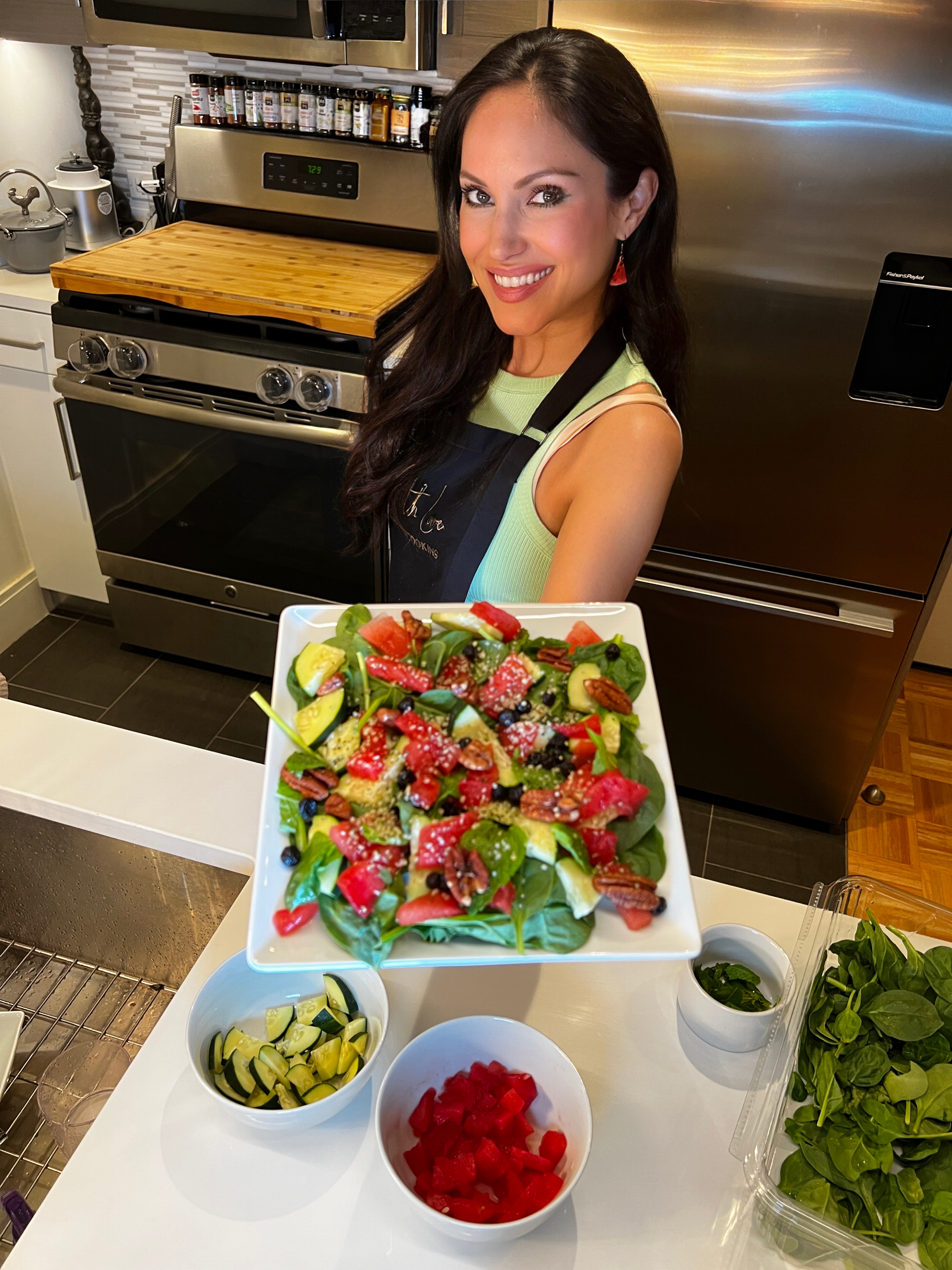 vegan chef holding a plate of colorful salad
