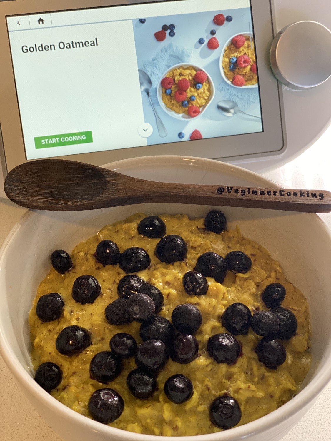 Golden Tumeric Oatmeal in bowl with spoon ontop