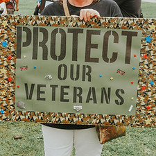Woman protests to protect veterans with