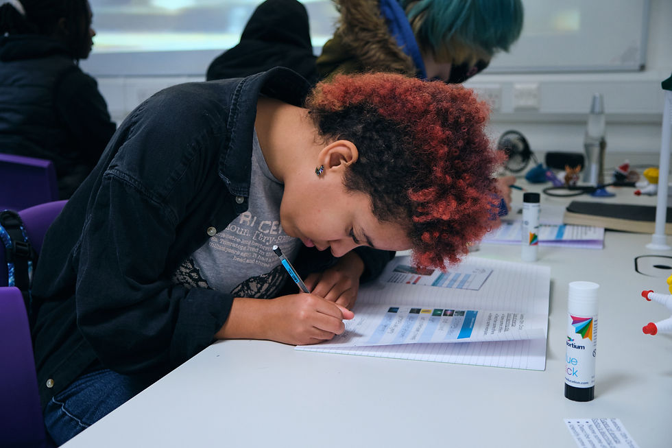 Image of student doing work in their workbook
