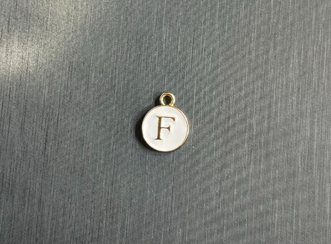 The White Circle "F" Charm