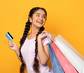 indian-woman-holding-credit-card-and-shopping-bags-2025-03-18-17-24-16-utc.jpg