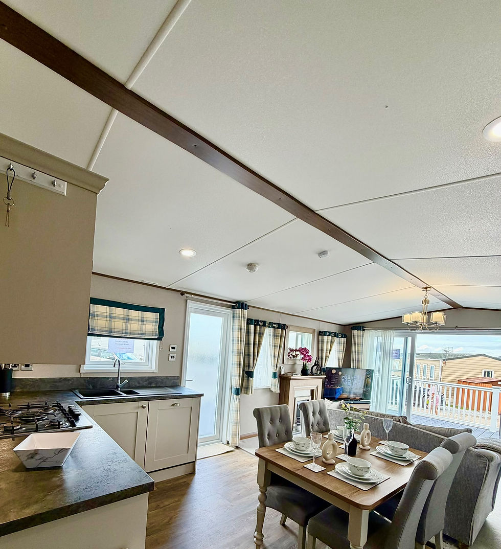 ABI Beaumont open-plan kitchen and dining area looking towards the lounge and glazed front doors.