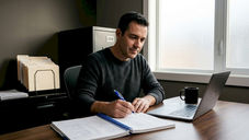 Landlord updating rental LLC records at home desk