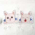 two Honkai Star Rail peppy stickers looking and yawning on white textile