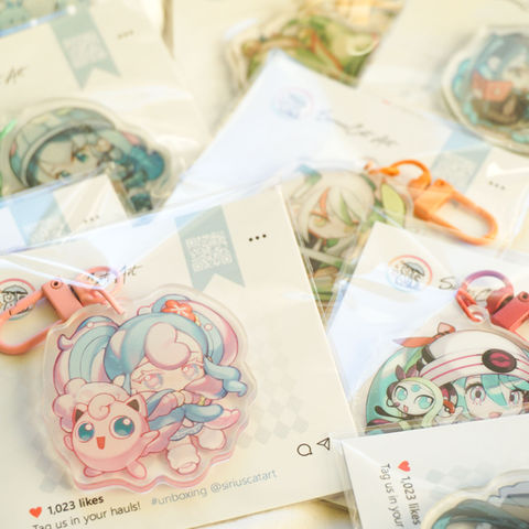 Assorted Pokemon Hatsune Miku keychains in a pile with Fairy Miku in the front