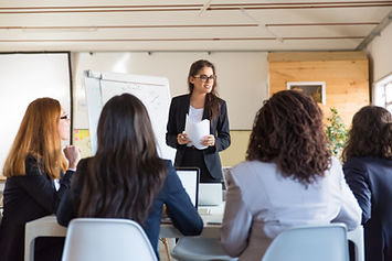 businesswomen-looking-speaker-with-papers.jpg