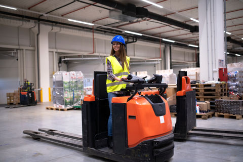 factory-worker-in-protective-suit-with-hardhat-driving-forklift.jpg