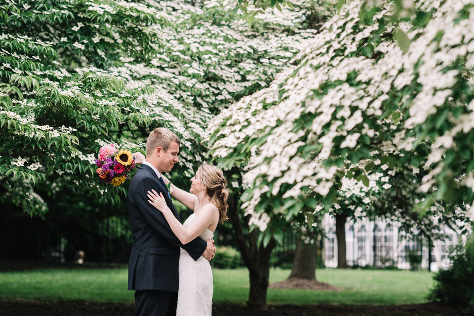 A couple portrait in front of crepe myrtle trees