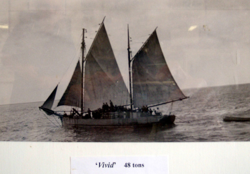 The Vivid with a deck load of bagged grain and a crowd of sightseers on board