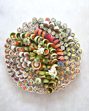 Shop a sushi platter with assorted rolls and floral garnishes