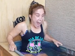 Young woman gasps in ice bath