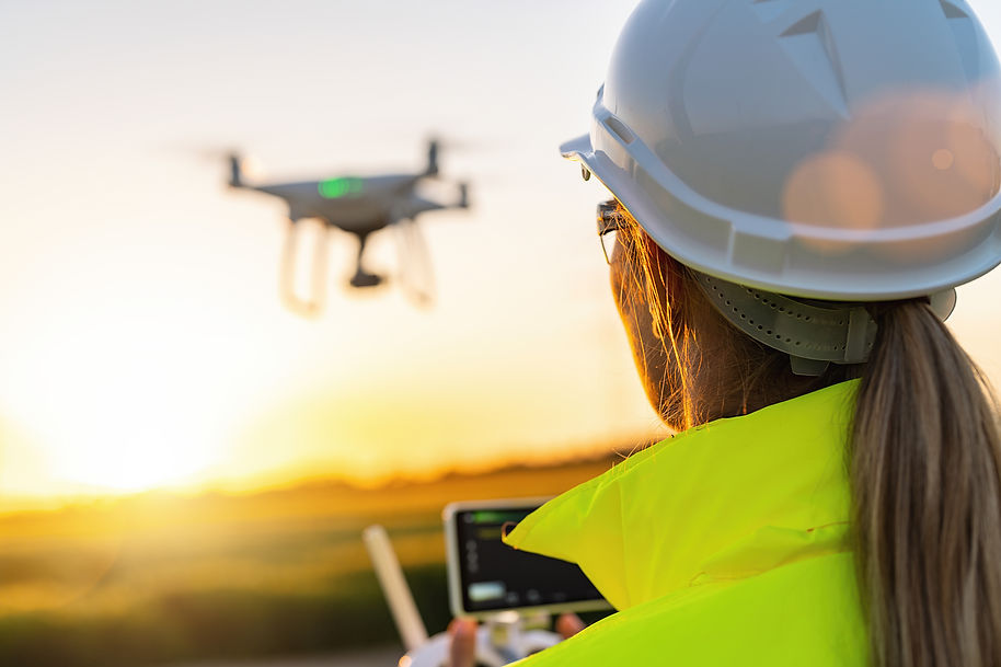 Drone inspection. Female Operator inspecting Wind turbine with drone. renewable energy con