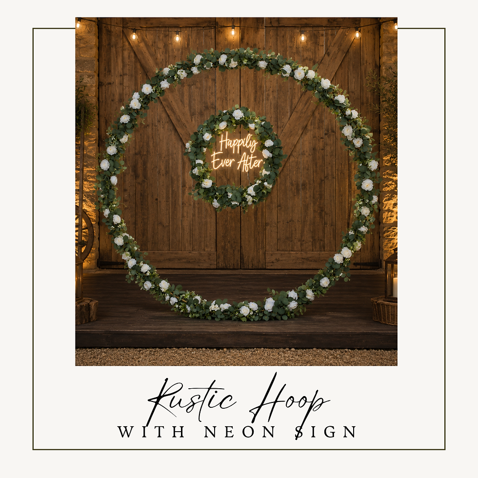 Large rustic floral hoop backdrop with greenery, white flowers and Happily Ever After neon sign.