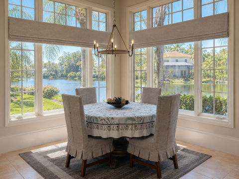 Dining room setting with refreshed valances and custom slipcovered dining chairs