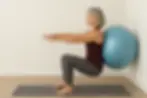 Build Leg Strength and Improve Balance With This Wall Squat Using a Stability Ball. Learn More Here!