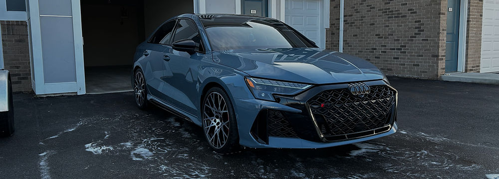 Recently washed blue car with soap suds