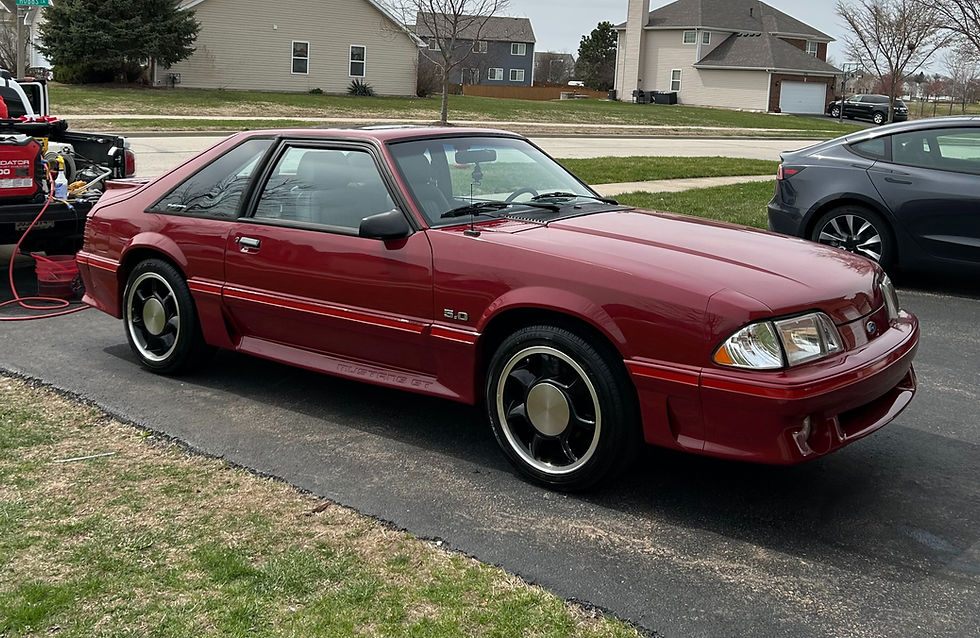 Red Ford Mustang parked washed and waxed with mobile detailing