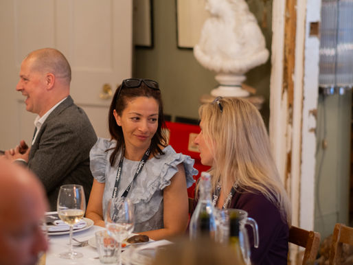 2 women sitting at a table and talking to eachother