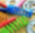 Brightly powder-coated suspension springs in blue, green, red, and yellow, demonstrating custom detailing options available through Rhino Coatings.