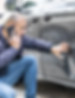 Middle-aged man on the phone inspecting a dent on his grey car door, illustrating a typical scuff or dent repair scenario handled by Foxhills Body Shop in Scunthorpe.