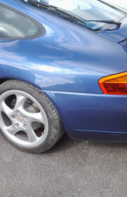 Rear quarter of a blue Porsche with flawless bumper respray, reflecting the high-quality, careful restoration work by Foxhills Body Shop.