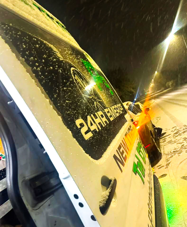 Roadside recovery vehicle in rain, representing PT Tyres’ 24/7 emergency tyre help.