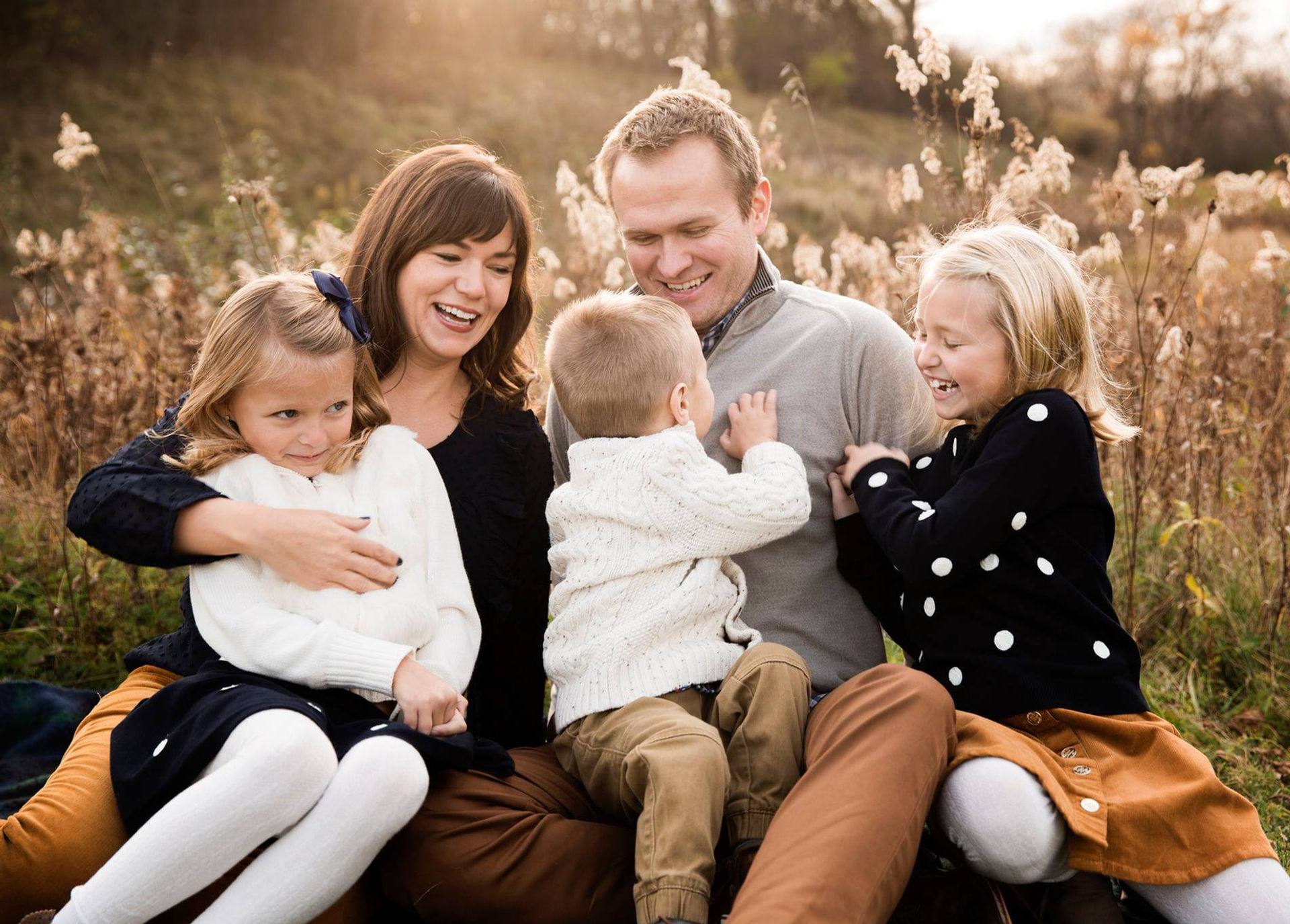 a family gathers, laughter echoing, capturing the warmth of autumn's embrace in a serene field