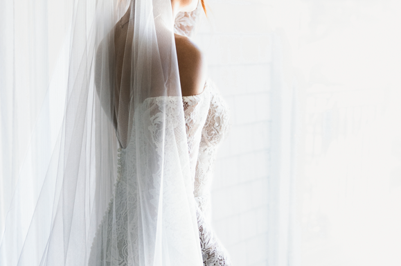 Classic bride standing in the window before the wedding