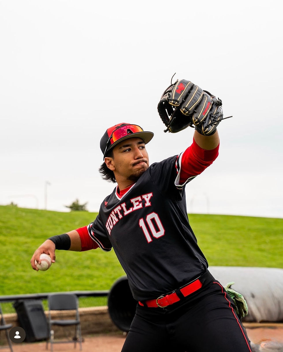 Baseball player in black and red HUNTLEY jersey, number 10, throws a ball on a field with glove raised, focused expression.