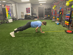 A baseball athlete performing a strengthening exercise. 