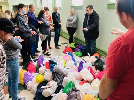Praying over items that will be distributed to the Migrant Workers.