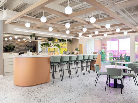 Modern office kitchen and breakout area with bar seating and meeting space