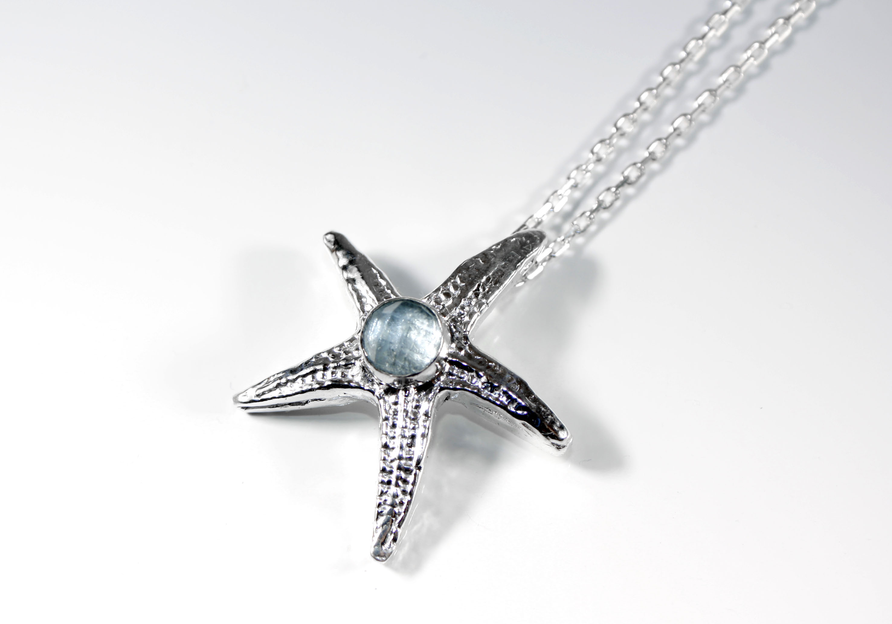 Custom made fine silver starfish pendant set with faceted aquamarine